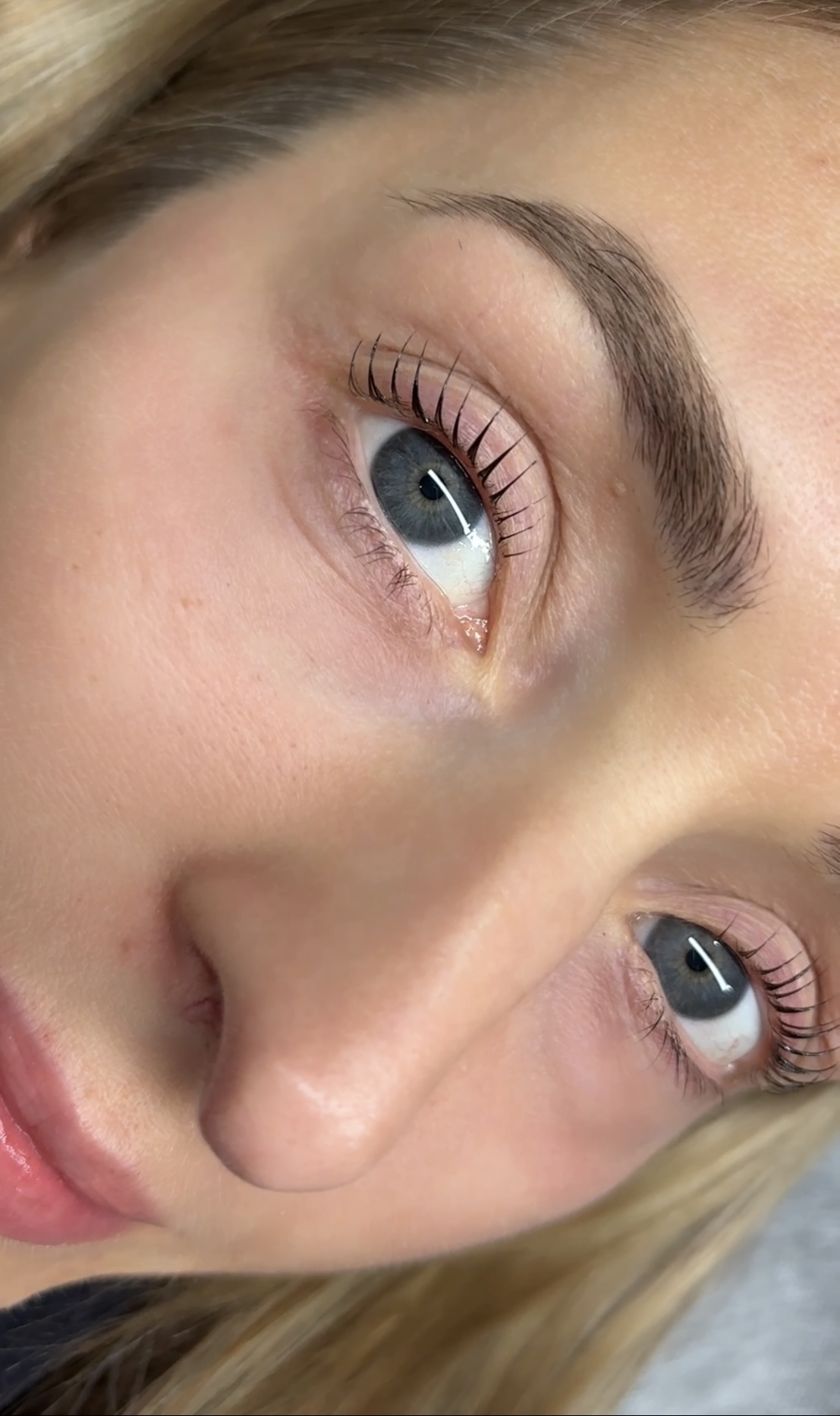 Client showing beautiful lash lift results, full face